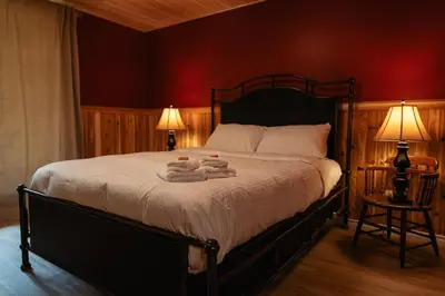 a bedroom with a bed with two towels on it at Bear Valley Highlands in Lumby