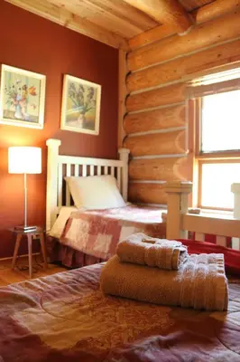 a bedroom with a bed in a log cabin at Bear Valley Highlands in Lumby