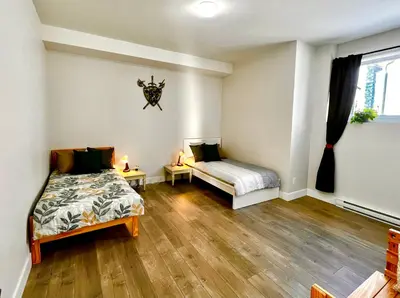 a bedroom with two beds and a window at Kelowna new lake view 2bedrooms close BIG WHITE in Kelowna