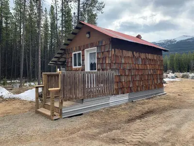 a small wooden cabin with a red roof at Jade City Dog House in Jade City