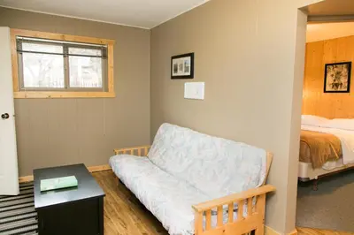 a bedroom with a couch and a bed and a table at Lone Star Motel in Rossland