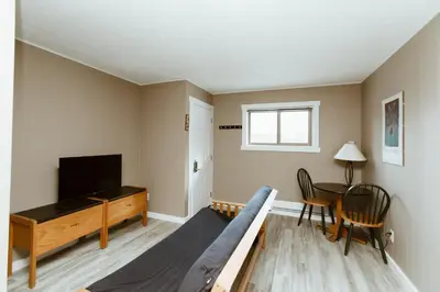 a living room with a bed and a television at Lone Star Motel in Rossland