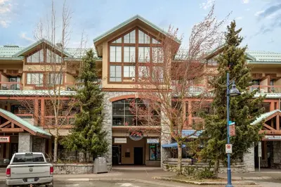 a large building with trees in front of it at The Après, Village Studio with Hot Tub and View in Whistler