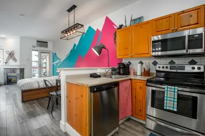 a kitchen with a sink and a stove at The Après, Village Studio with Hot Tub and View in Whistler