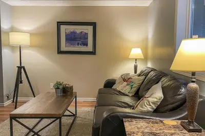 a living room with a couch and a table at The Norquay, Pet-Friendly 2 Bed with Mtn View in Canmore
