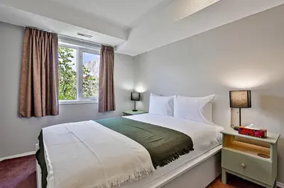 a bedroom with a large bed and a window at The Norquay, Pet-Friendly 2 Bed with Mtn View in Canmore