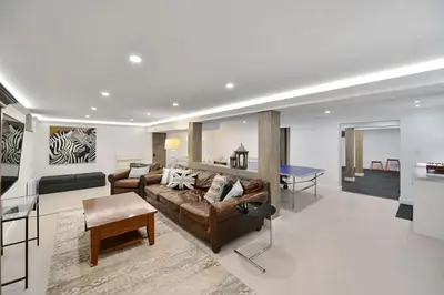a living room with a couch and a ping pong table at Beachside Living Cherry Point by EMR Vacation Rentals in Cobble Hill