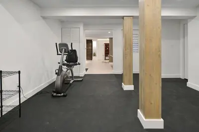 a room with a gym with a exercise bike at Beachside Living Cherry Point by EMR Vacation Rentals in Cobble Hill