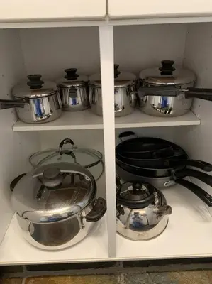 a shelf with pots and pans in a kitchen at Chris Cozy Condo Commonwealth #205 Edmonton in Edmonton