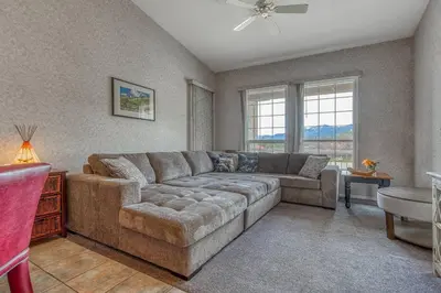 a living room with a couch and a table at Cozy Fairmont Hot Springs 1BR Condo in Fairmont Hot Springs