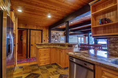 a kitchen with wooden walls and a wooden ceiling at Mountain Retreat, Panoramic Lake Views in Invermere