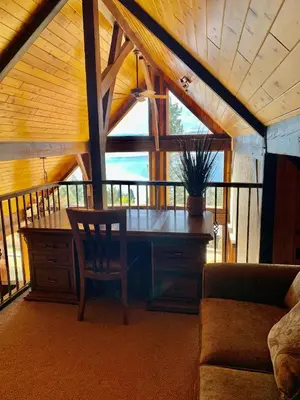a living room with a table and a couch at Mountain Retreat, Panoramic Lake Views in Invermere