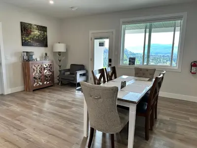 a dining room with a table and chairs at Shannon Heights B&B in West Kelowna