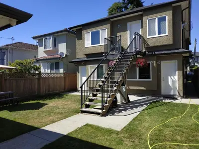 a house with a spiral staircase in the yard at Private Suite w King Bed, Ground Level, Naturally Bright in Vancouver