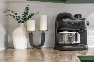 a coffee maker and two candles on a counter at The Sleeping Moose I Fireplace I Pool Table I TV in Fairmont Hot Springs