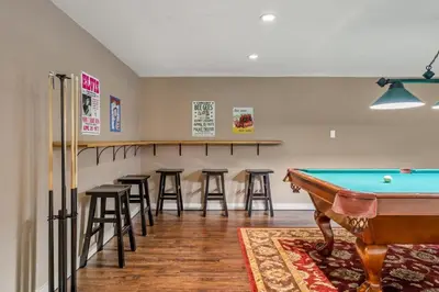 a pool table in a room with bar stools at The Sleeping Moose I Fireplace I Pool Table I TV in Fairmont Hot Springs