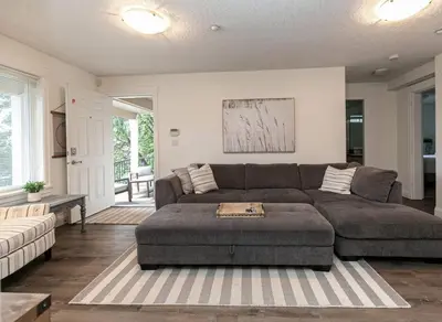 a living room with a couch and a table at Cozy Renovated Oasis W Private Terrace & Parking in Victoria