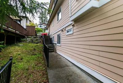 a sidewalk next to a house with a fence at Cozy Renovated Oasis W Private Terrace & Parking in Victoria