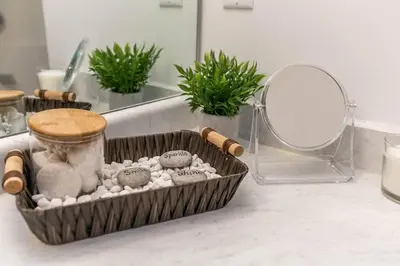 a container of rocks and a mirror on a counter at Spacious 2bedroom FREE parking king bed close to DT in Edmonton