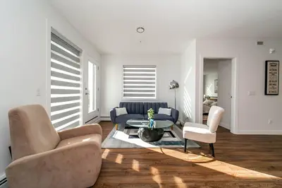 a living room with a couch and a table and chairs at Spacious 2bedroom FREE parking king bed close to DT in Edmonton