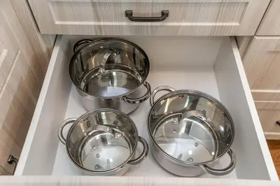 four pots and pans in a drawer in a kitchen at Spacious 2bedroom FREE parking king bed close to DT in Edmonton
