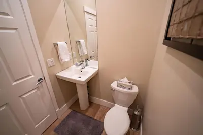 a small bathroom with a toilet and a sink at Aspen Lodge by Revelstoke Vacations in Revelstoke