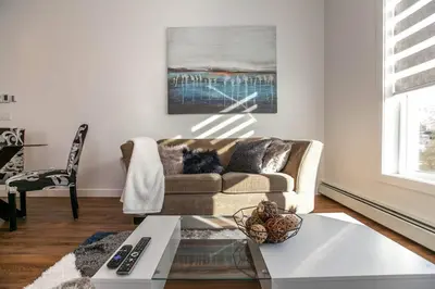 a living room with a couch and a table at Stylish Close to D/T FREE parking King Bed 2bed in Edmonton