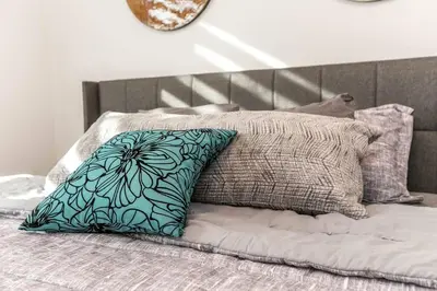 a pillow sitting on top of a bed at Stylish Close to D/T FREE parking King Bed 2bed in Edmonton