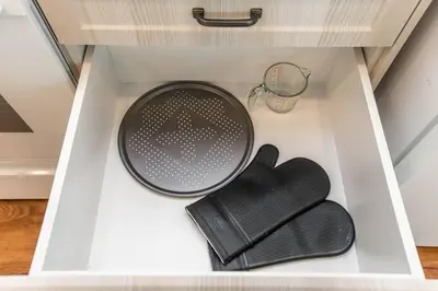 a drawer with a plate and a glove in it at Stylish Close to D/T FREE parking King Bed 2bed in Edmonton