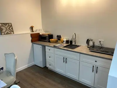 a kitchen with a counter with a sink and a microwave at Chic Romantic3bed patio WIFI quiet retreat parking in Calgary