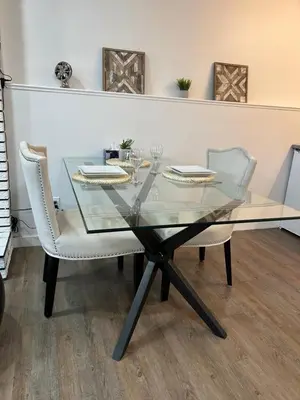 a glass dining table with two chairs and a glass table at Chic Romantic3bed patio WIFI quiet retreat parking in Calgary