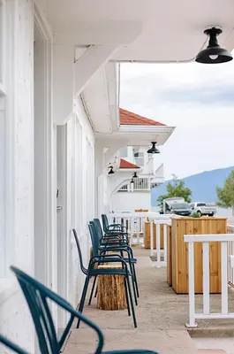 a row of chairs sitting on a porch of a building at Kettle Valley Beach Resort in Penticton