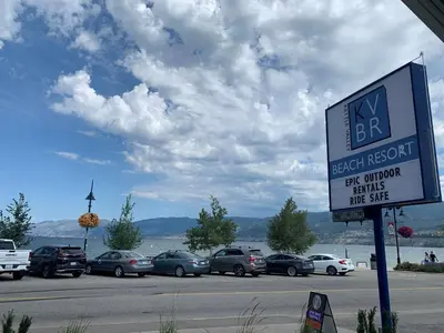 a sign for a parking lot with cars parked at Kettle Valley Beach Resort in Penticton