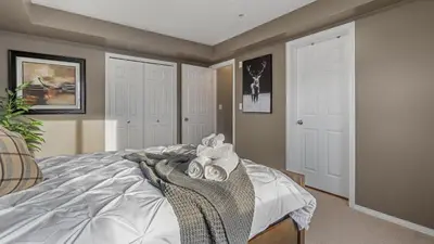 a bedroom with a bed with towels on it at Cozy Mountain I Hot Tub & Pool I Close 2 Lake I TV in Invermere
