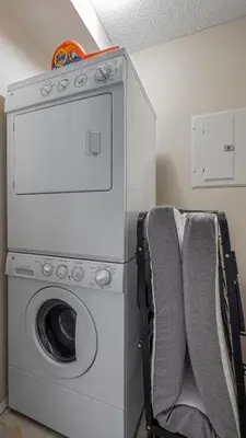 a laundry room with a washing machine and a washer at Cozy Mountain I Hot Tub & Pool I Close 2 Lake I TV in Invermere