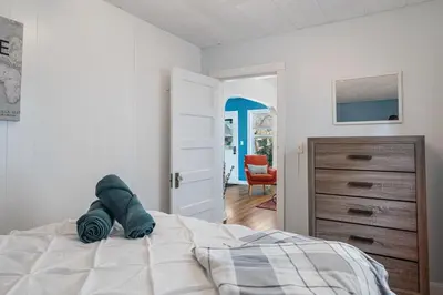 a bedroom with a bed and a chair in it at Dino Cave l Walk to Downtown l Fire Pit & BBQ I TV in Drumheller