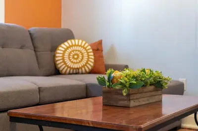 a living room with a couch and a coffee table at Dino Cave l Walk to Downtown l Fire Pit & BBQ I TV in Drumheller