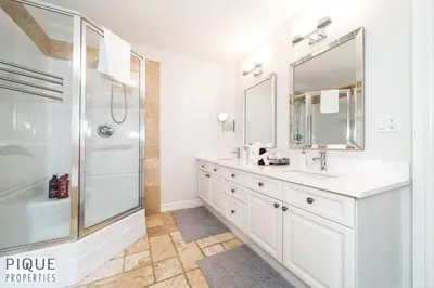 a white bathroom with a shower and a sink at LUXURIOUS 6 Bed Home I Fireplace I near Sports Park I with Double Garage & Fast WiFi! in Edmonton