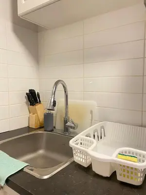 a kitchen sink with a faucet and two baskets at lovely home in Calgary