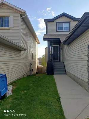 a house with a driveway leading to the front door at lovely home in Calgary