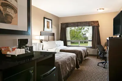 a hotel room with two beds and a window at Ramada by Wyndham Conklin in Conklin