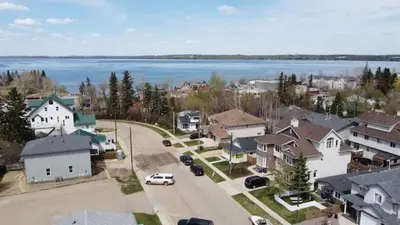 an aerial view of a small town with a lake at Prairie Oasis I Sleeps 16 l BBQ & Patio l Smart TV in Sylvan Lake