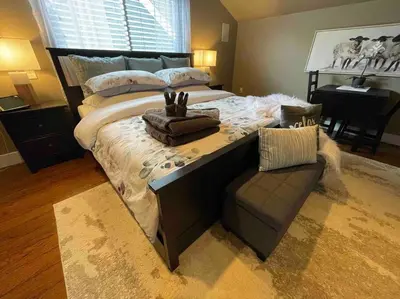 a bedroom with a large bed and a couch at Cozy loft in Upper Gibsons in Gibsons