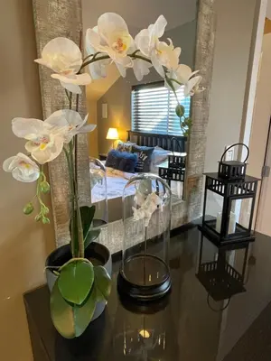 a living room with a table with flowers on it at Cozy loft in Upper Gibsons in Gibsons