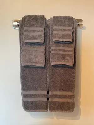 four towels hanging on a towel rack in a bathroom at Cozy loft in Upper Gibsons in Gibsons