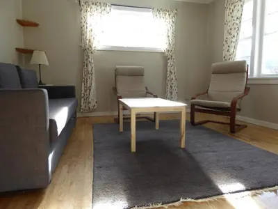 a living room with a couch and a table and two chairs at Banff Beaver Cabins in Banff