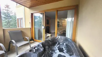a bath tub in a room with a window at Snow Creek Village #49 in Sun Peaks