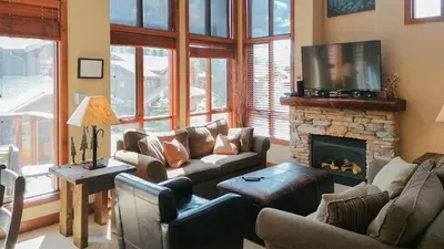 a living room with a couch and a fireplace at Woodhaven #19 by Bear Country in Sun Peaks