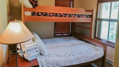 a bedroom with a bunk bed and a lamp at Woodhaven #19 by Bear Country in Sun Peaks