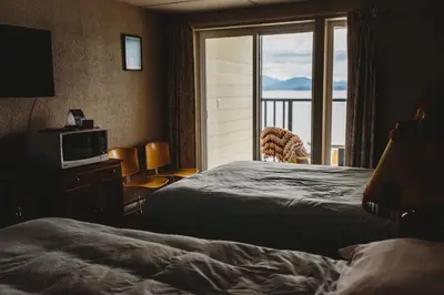 a hotel room with two beds and a window at The Oceanfront Hotel in Sointula